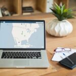 A laptop displaying VPN software sits on a wooden desk with a notepad and plant offering a secure workspace vibe.