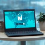 Laptop displaying a security lock icon on a table with a potted plant and clock.