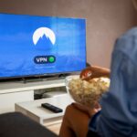 A relaxed scene at home with a person enjoying popcorn while watching a VPN-protected TV.